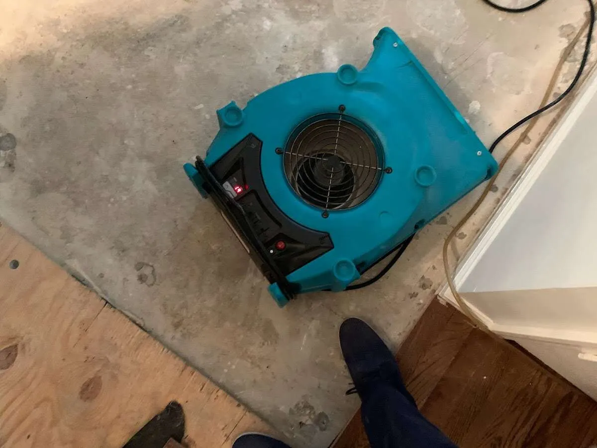Air mover drying subfloor during Commercial Water Damage Restoration in Upper Saucon